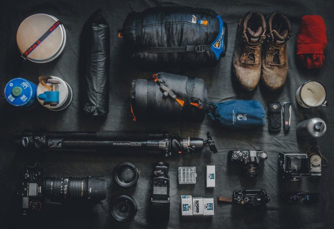 Equipamiento fotográfico y de senderismo, incluyendo cámaras, zapatos y accesorios.